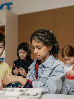 Children collaborating on robotics project in a classroom setting, fostering technology learning.