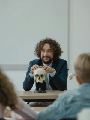 Teacher engaging students with a skull model in an interactive biology lesson.